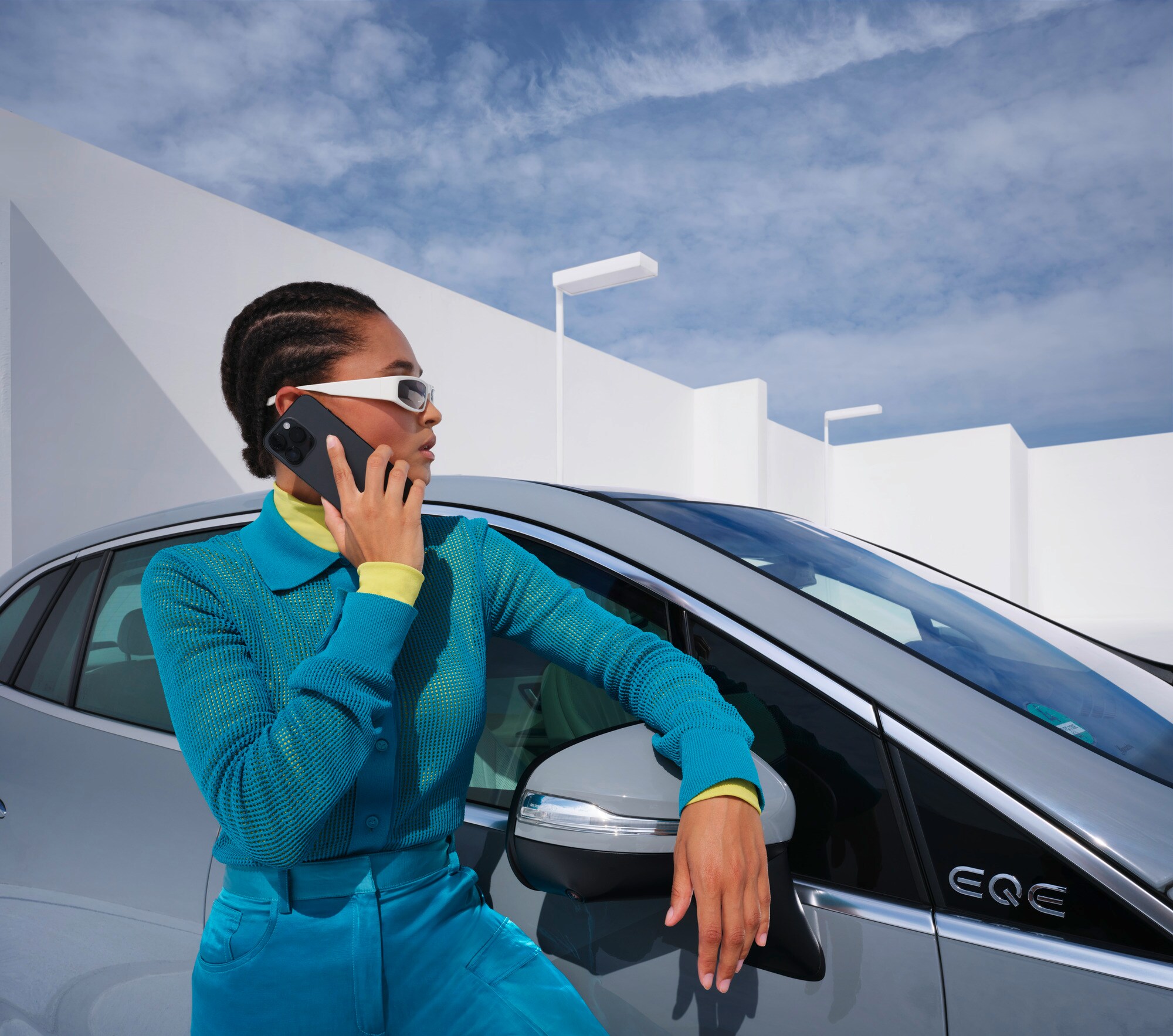 Damage and Breakdown | Mercedes-Benz Woman leaning on her Mercedes-Benz on the phone.