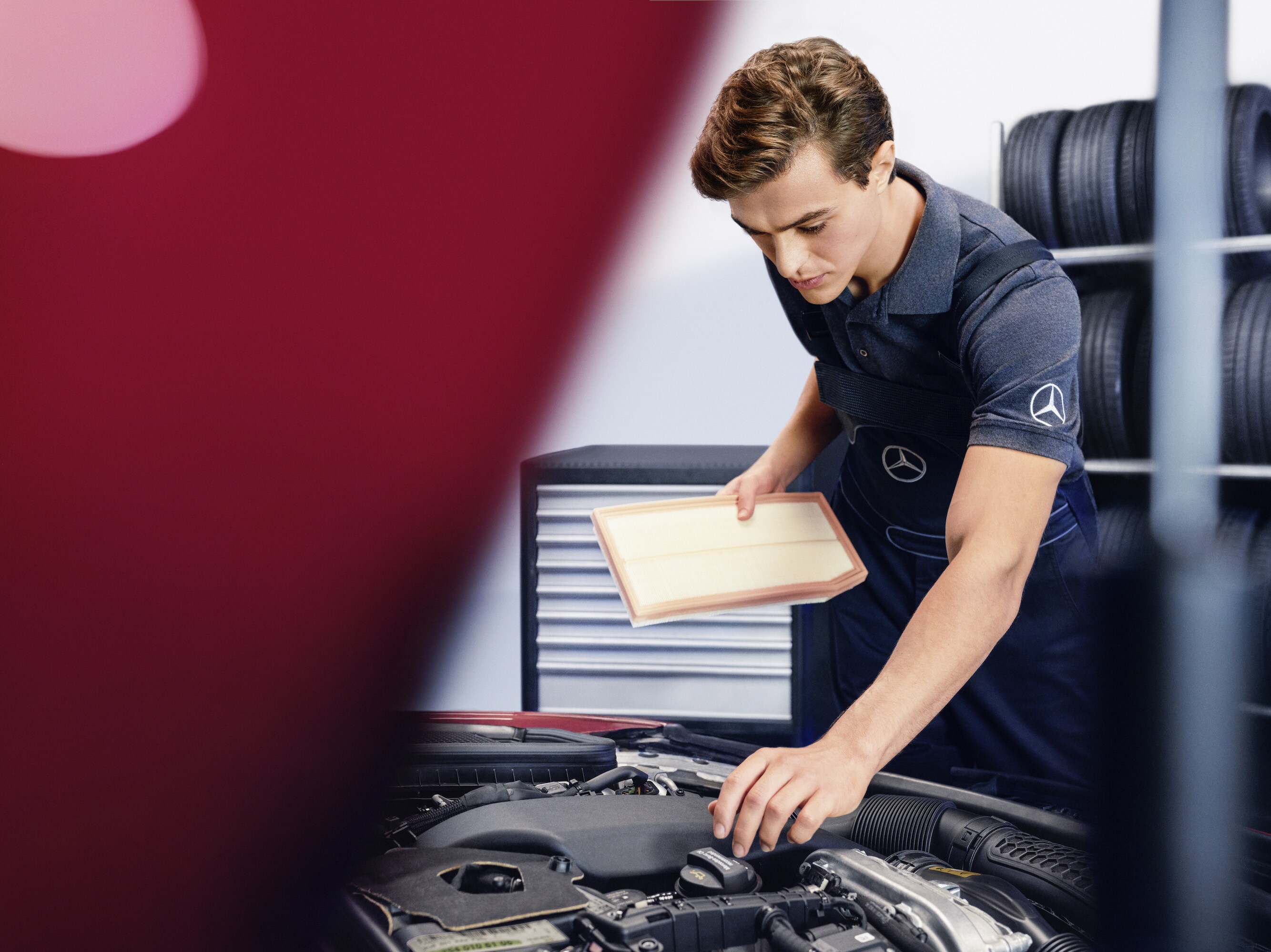 Air filter | Mercedes-Benz A technician checking the engine of the Mercedes-Benz vehicle.
